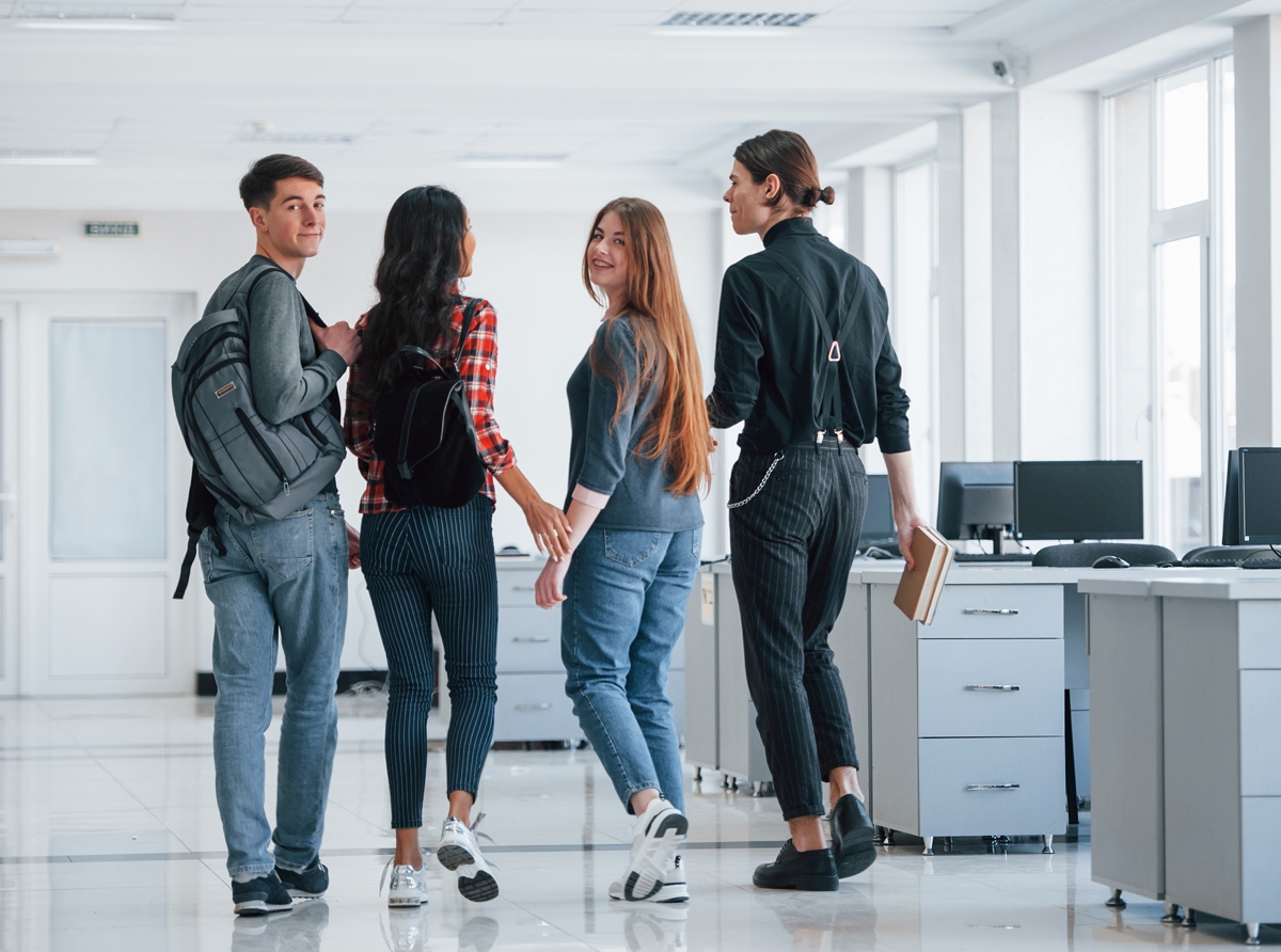 A group of happy students at a career day event, engaging with career counselors and exploring future job opportunities, symbolizing AI-driven career guidance through the UNIRANKS Career Path Initiative.