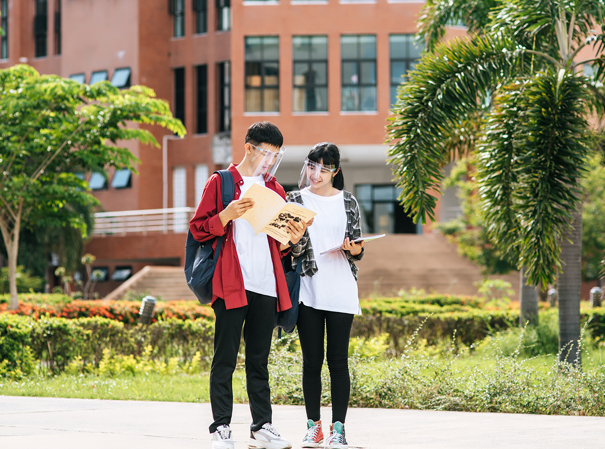 Two students walking inside a university campus, exploring academic opportunities in a global education hub.